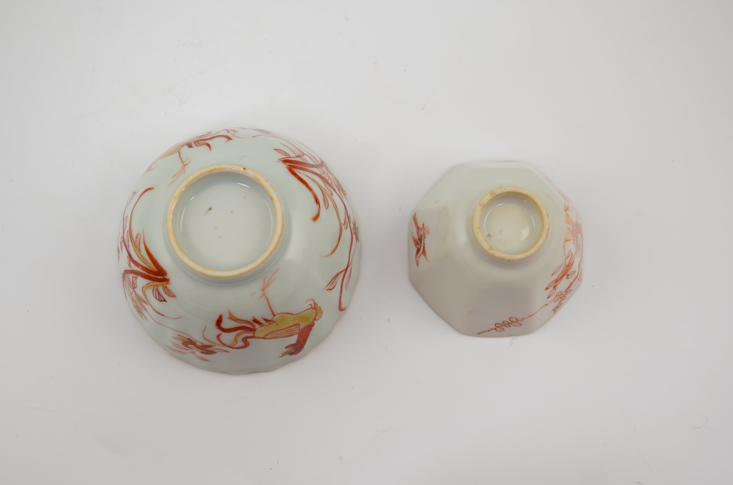 A Chinese rouge de fer tea bowl and saucer and a similar cup, Qianlong period